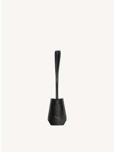 The Yore Key Chain made of black vegetable-tanned leather with white stitching and a subtle embossed logo.