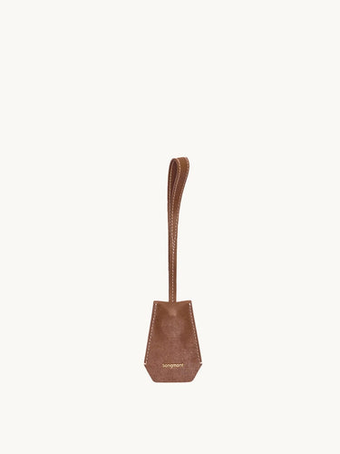 Sandal colored Yore Key Chain crafted from vegetable-tanned leather with white stitching and embossed Songmont logo.