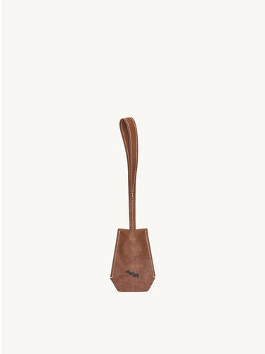 Sandal brown Yore Key Chain made of vegetable-tanned leather with embossed logo, perfect as a bag charm or key holder.