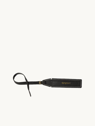 Yore Luggage Tag: black vegetable-tanned leather with white stitching and gold buckle. Features 'Songmont' embossed.