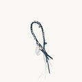 Tranquil Crystal Charm with braided cord, silver bells, and leather tassels.