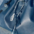 Tranquil Crystal Charm: blue leather bag, braided charm, crystal pendant, Moonstone color, Songmont tag.