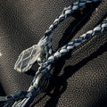 Tranquil Crystal Charm with moonstone crystal, silver bead, and braided blue & white cord on black leather bag.