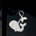 White vegan leather whale charm with tail, made from recycled ocean plastic. Eco-friendly accessory.