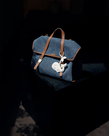 Vegan Charm bag in Whale (Eco Cloud) color with a white whale charm attached.