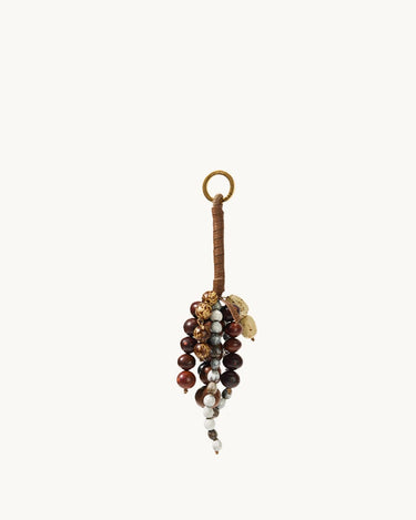 Caramel Wish Seeds Charm with assorted natural beads and a leather-wrapped loop.