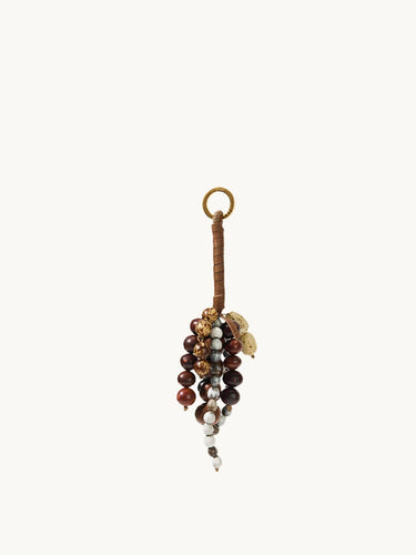 Caramel Wish Seeds Charm with assorted natural beads and a leather-wrapped loop.