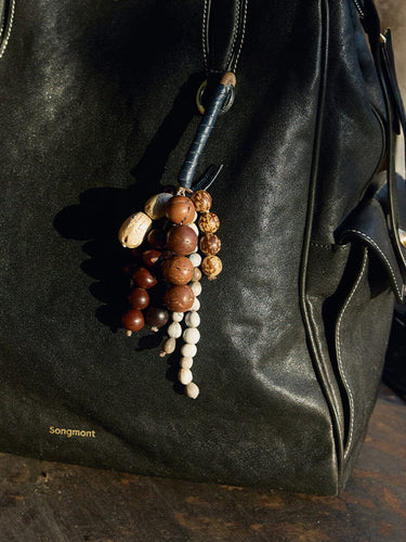 Denim Wish Seeds Charm crafted from full-grain leather with a beaded charm featuring natural Bodhi seeds.