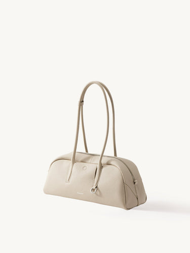 Yore Toast Bag in Cloud: Full-grain tumbled leather, rounded silhouette, baguette-inspired design, Songmont embossed logo.