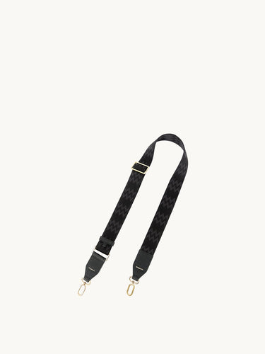 Yore Tote Bag Shoulder Strap in onyx, featuring a black fabric strap with a black and grey zigzag pattern and gold hardware.