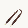 Brown fabric shoulder strap with herringbone pattern, leather accents, and gold hardware.