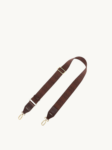 Brown fabric shoulder strap with herringbone pattern, leather accents, and gold hardware.